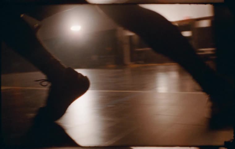 Feet of a person running on a basketball court