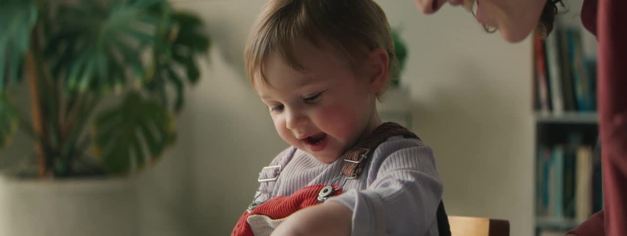 Mother with her little daughter interacting with a book in a happy way