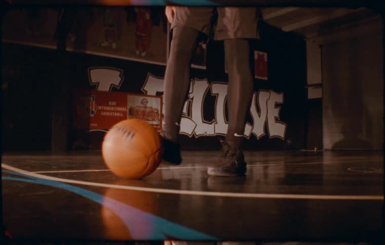 Boy dribbling a basketball on the court