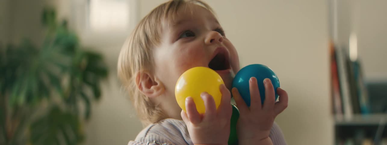 Portrait of a little girl playing with colorful balls