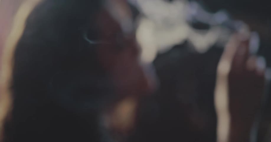 Woman smoking and exhaling smoke