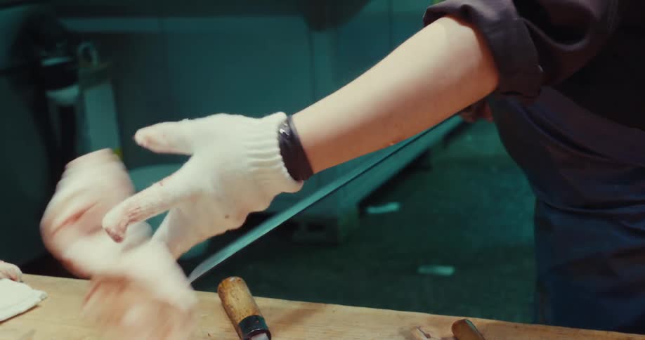 A butcher is cutting a large slab of meat