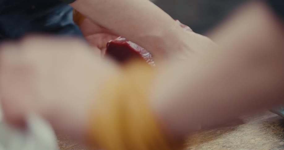 Hand handling a piece of fresh tuna