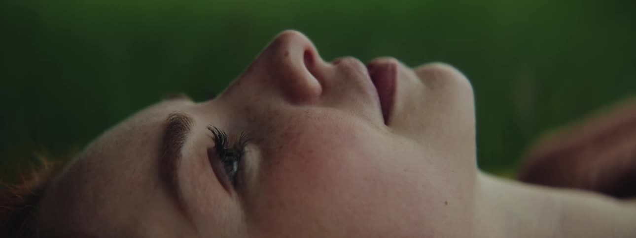Side portrait of a woman lying on grass