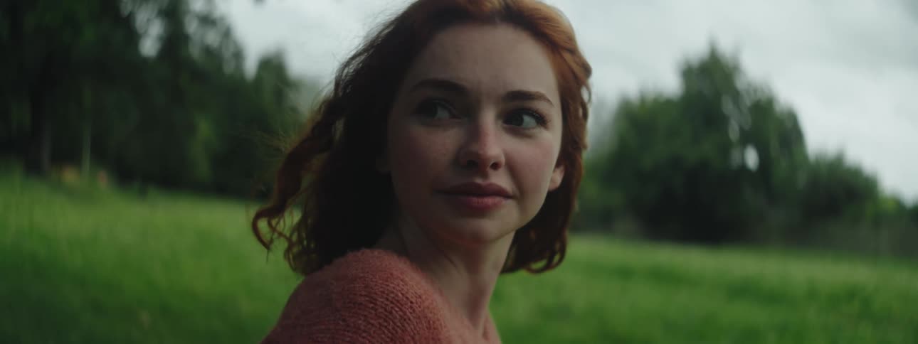 A woman smiles and turns her head