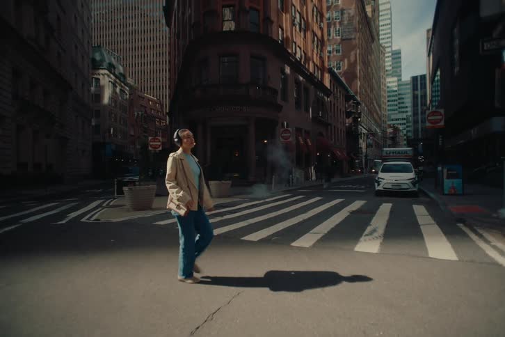 Woman with headphones walking through the city