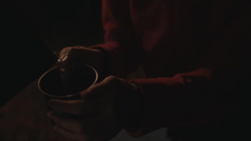 Water is poured into a mans cup