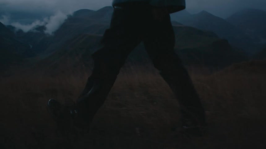 Legs of a person walking through mountains