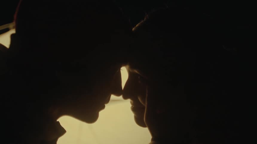 Silhouette of a man and a womans face glued together facing each other romantically