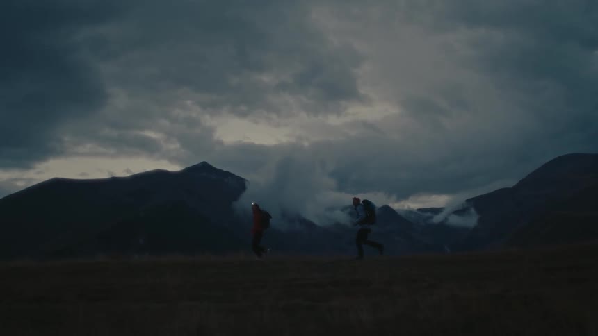 A night clip of two hikers running