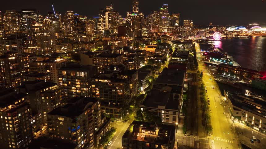 Low approach towards downtown Seattle from over the waterfront and Belltown neighborhood