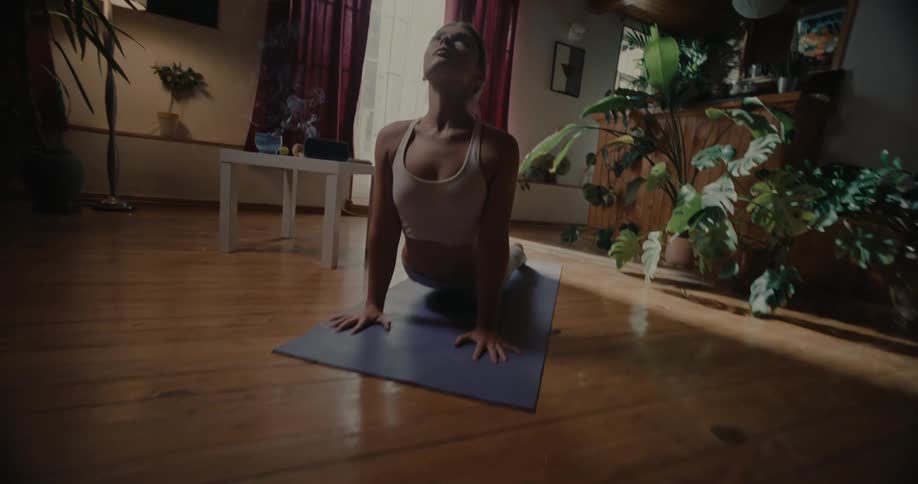 Woman lying on a fitness mat stretching her body