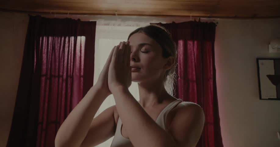 A woman is doing yoga at home