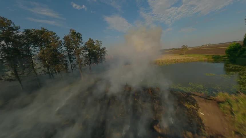 Panorama of a flat field on fire with an FPV drone