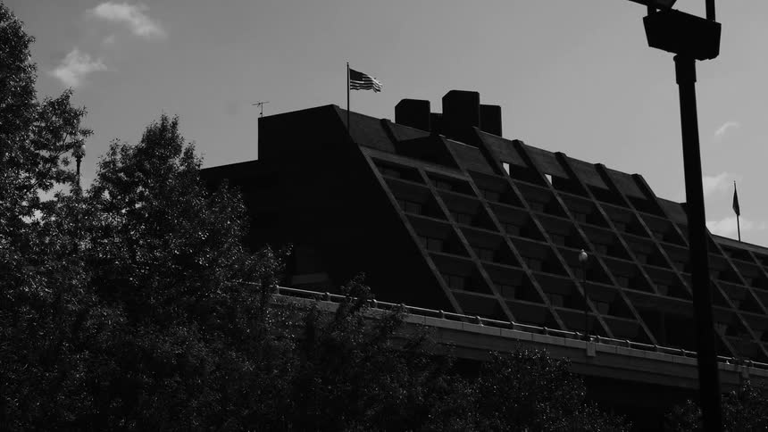 The american flag blows in the wind on the bulding