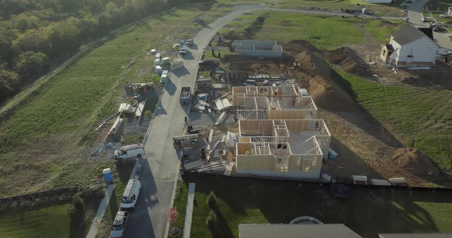 Houses being built by construction crews in a suburb
