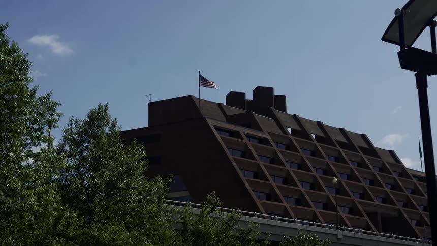 A tall brown building with many windows