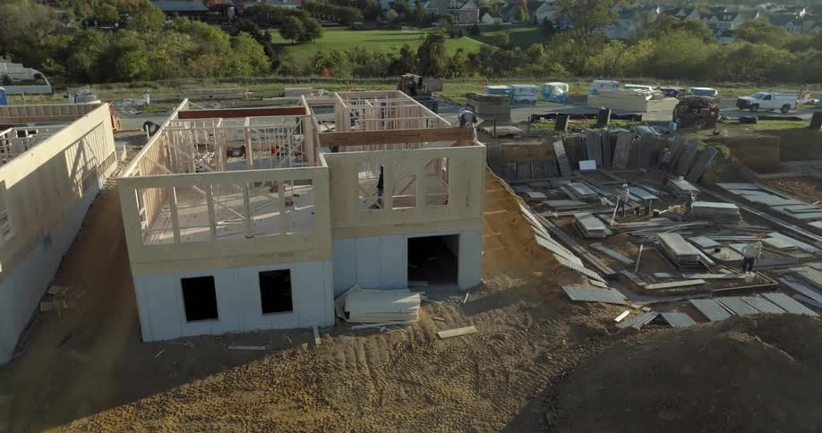 Aerial view of a group of workers working on a house construction site