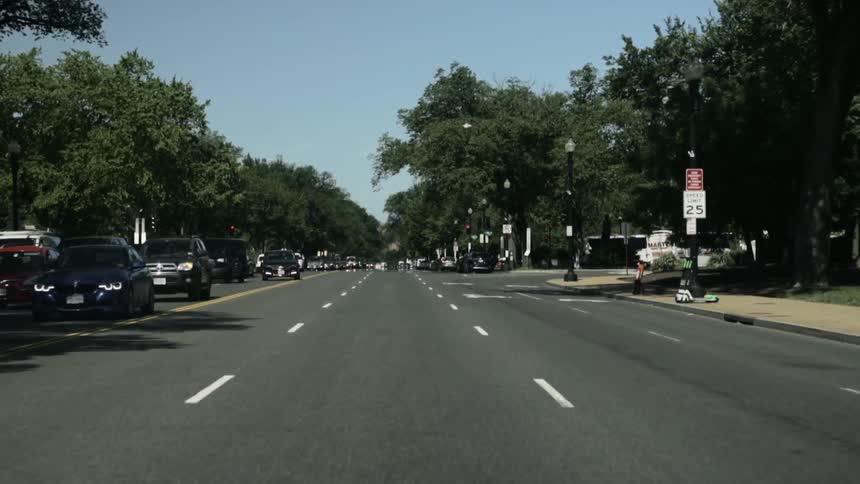 Moving view of a street with vehicle traffic during the day