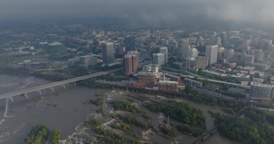 Aerial panorama of low clouds in a canalside metropolis