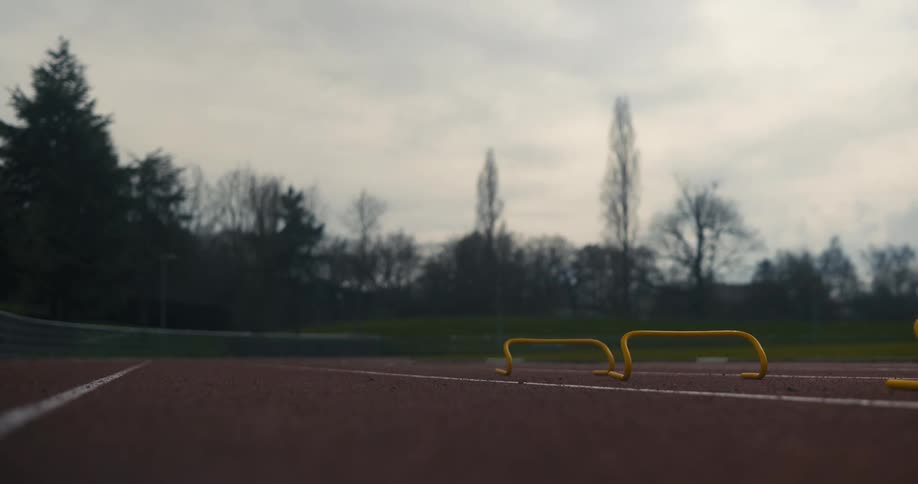 Close up of the legs of a runner sprinting on a running track