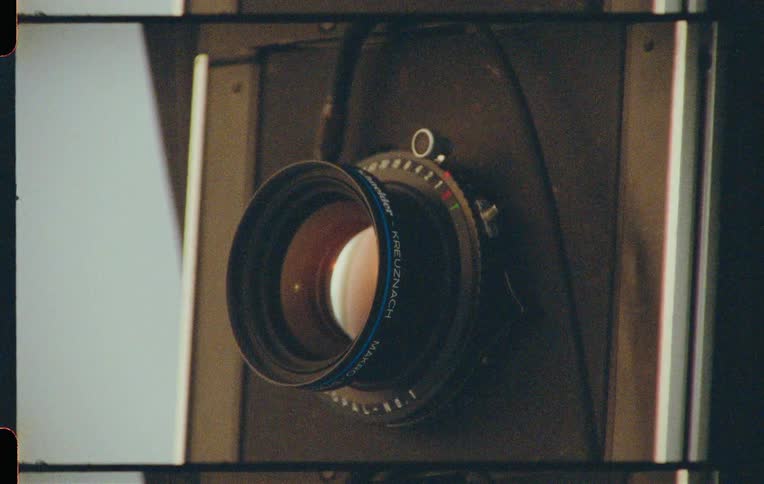 Hand adjusting the lens of a camera