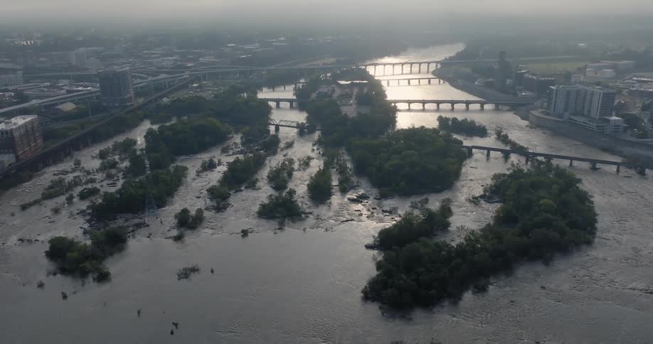 Aerial view of a wide river with several bridges crossing it in a metropolis