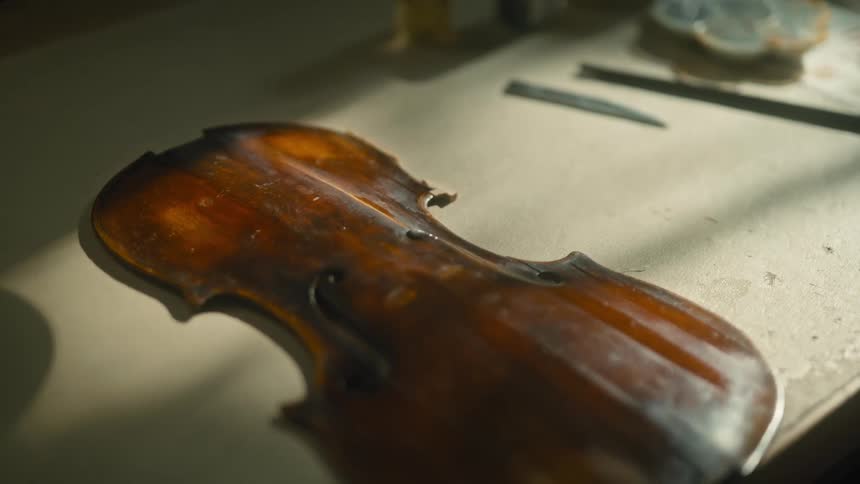 Close up of a wooden violin under construction