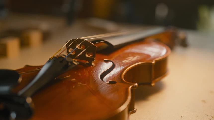 Lights shine back and forth on a newly constructed violin