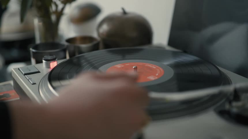 Hands putting a vinyl record to play