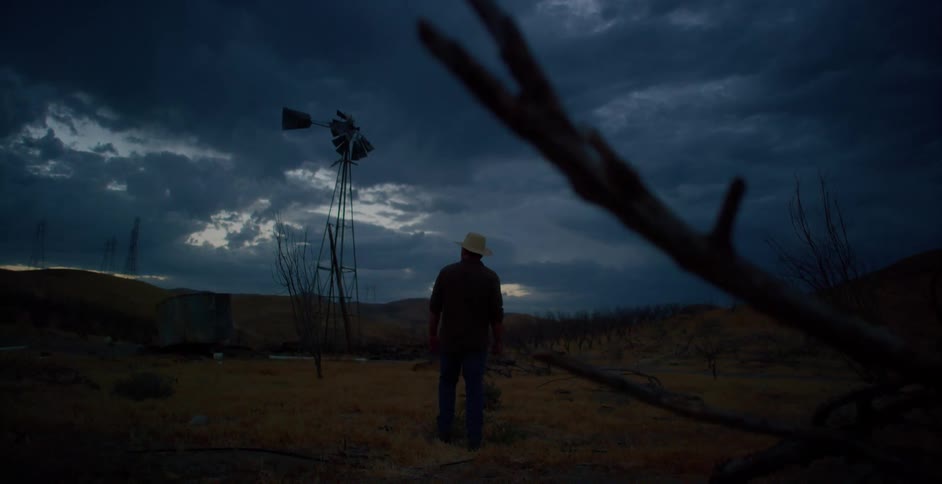 Man in hat walking in dry rural area