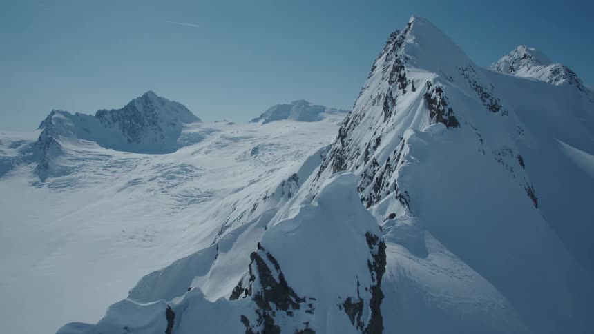 Aerial of a snowcovered mountain range on a sunny winter day
