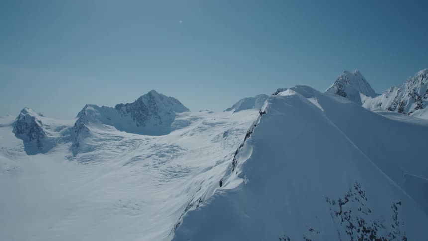 Aerial of a snowcovered mountain range on a sunny winter day