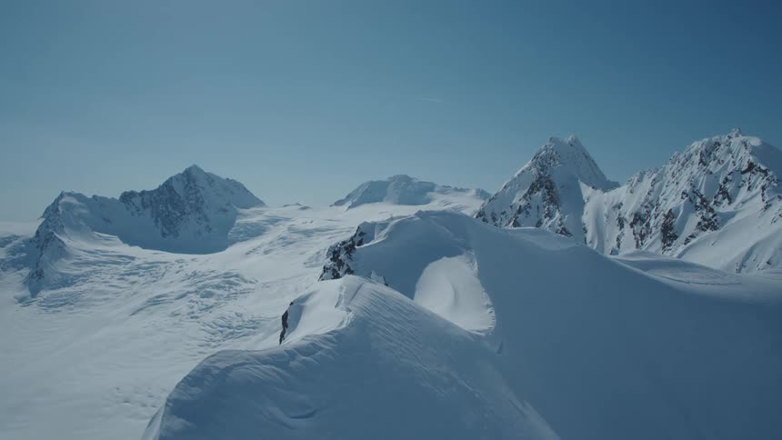 Aerial landscape of snowy mountains during daytime