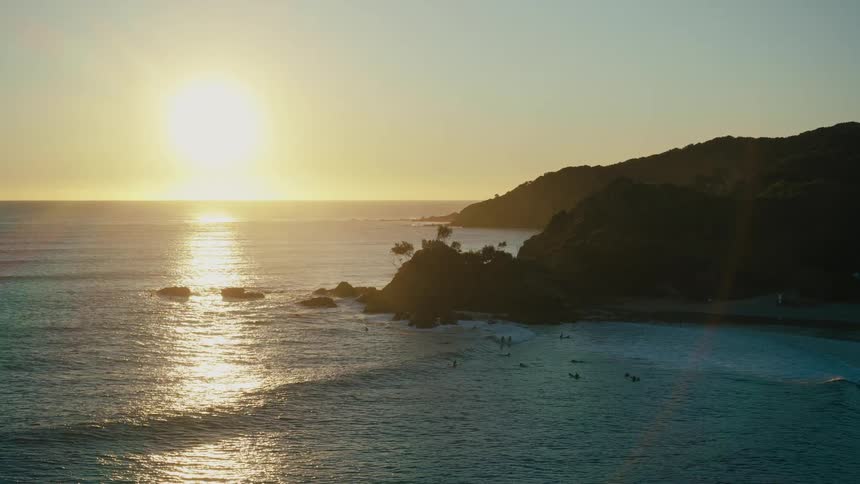 Birds fly around the coast of the island