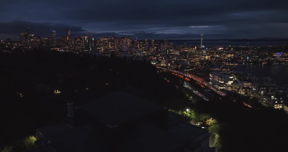 Reveal of downtown Seattle at night from over Capitol Hill