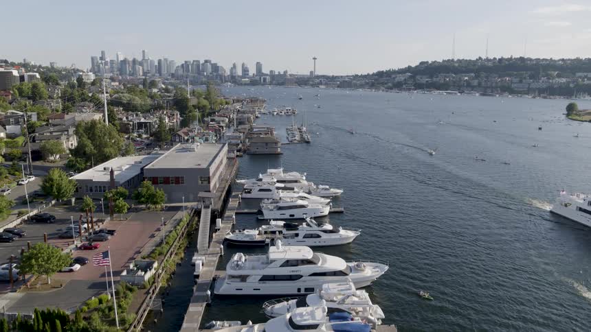 Boats and other people out on the water move along Lake Union past houseboats and condos on Eastlake