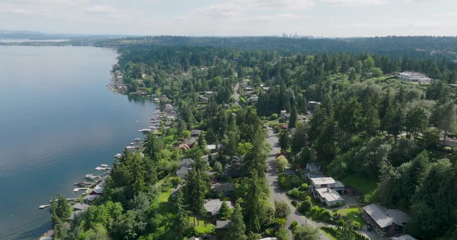 Suburban homes line the hillside near Lake Washington with the skyline of downtown Seattle far in the distance