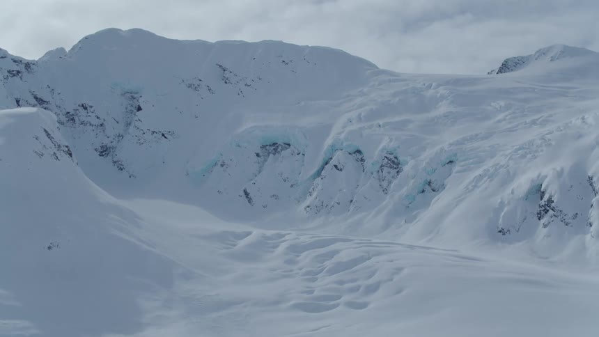 Aerial panorama of a mountain valley covered in snow