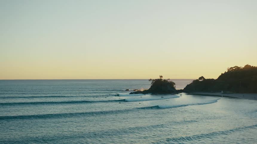 Aerial view of the sun setting over a coastal landscape