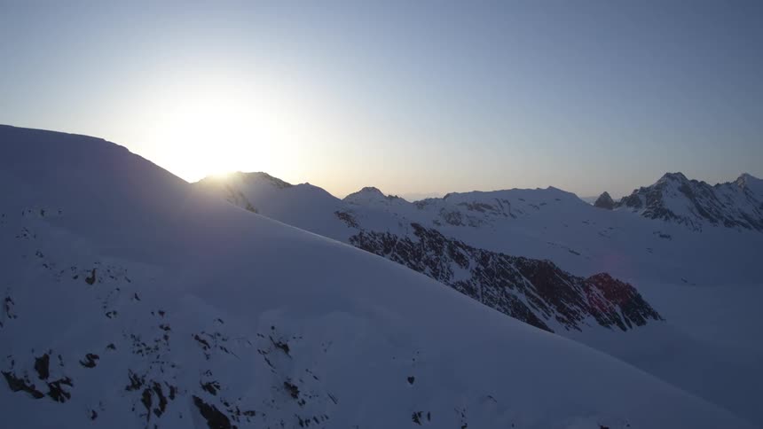Aerial of a snowcovered mountain range at sunrise