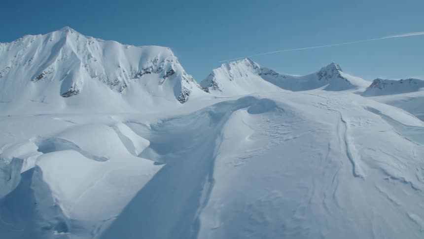 Mountains covered in snow under a perfectly blue sky