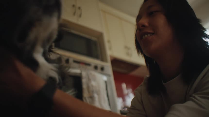 Woman petting her dog indoors
