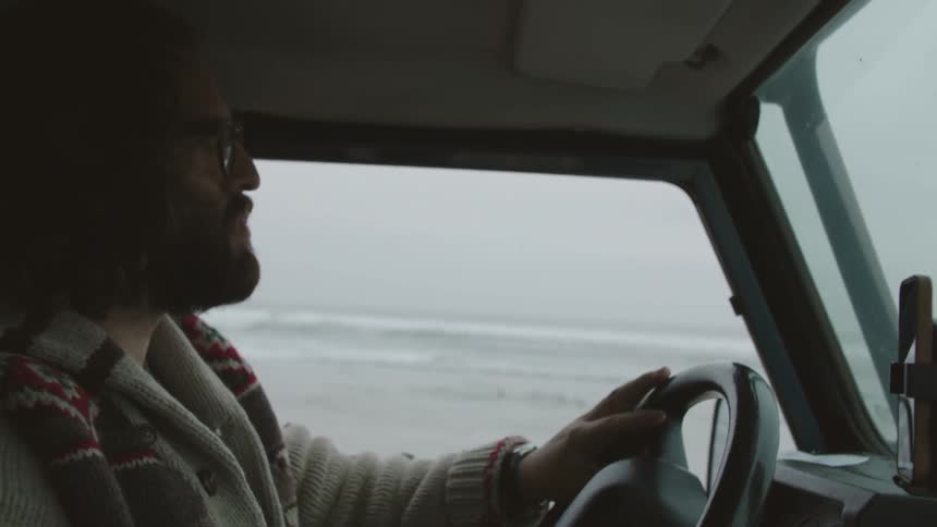 Man driving with the water directly out of his window