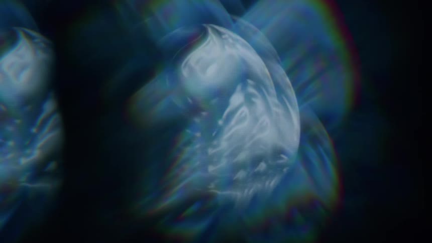 A collection of abstract iridescent shapes float against a dark background