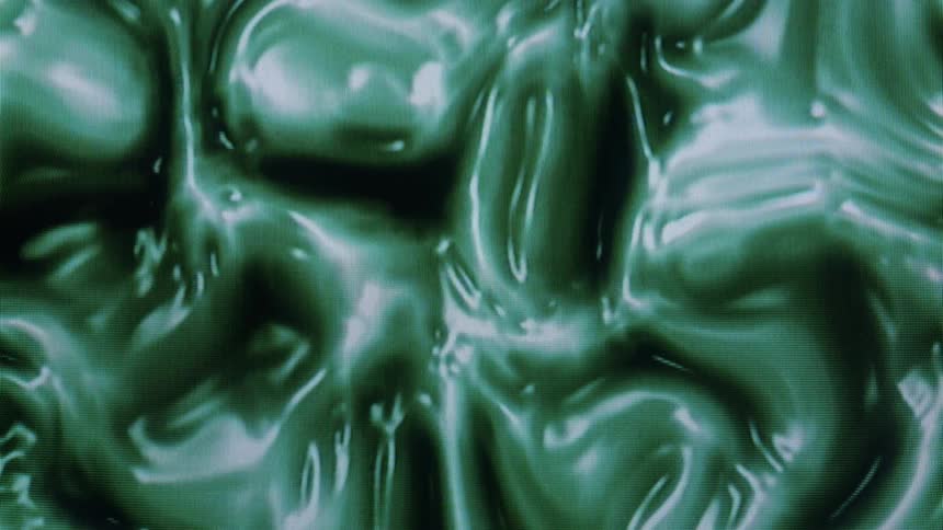 Close up of shiny green liquid swirling around