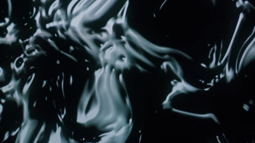 A close of clip of an abstract dark liquid form