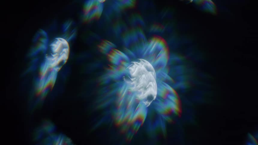 A collection of abstract iridescent shapes float against a dark background