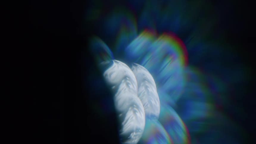 A collection of abstract iridescent shapes float against a dark background