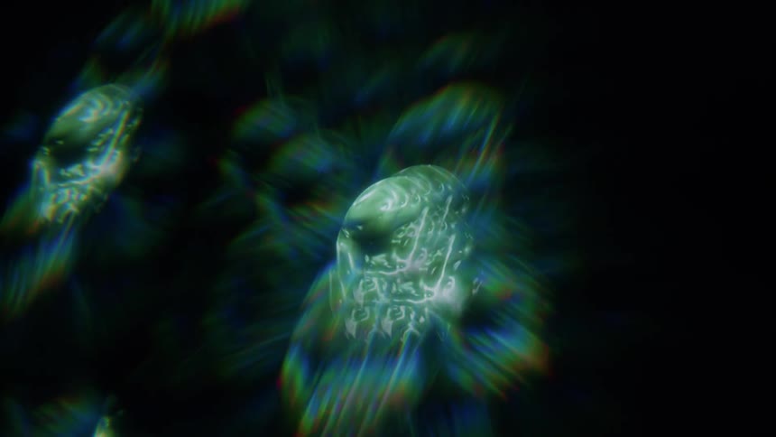 Extreme close up of an abstract object of green and blue lights against a black background